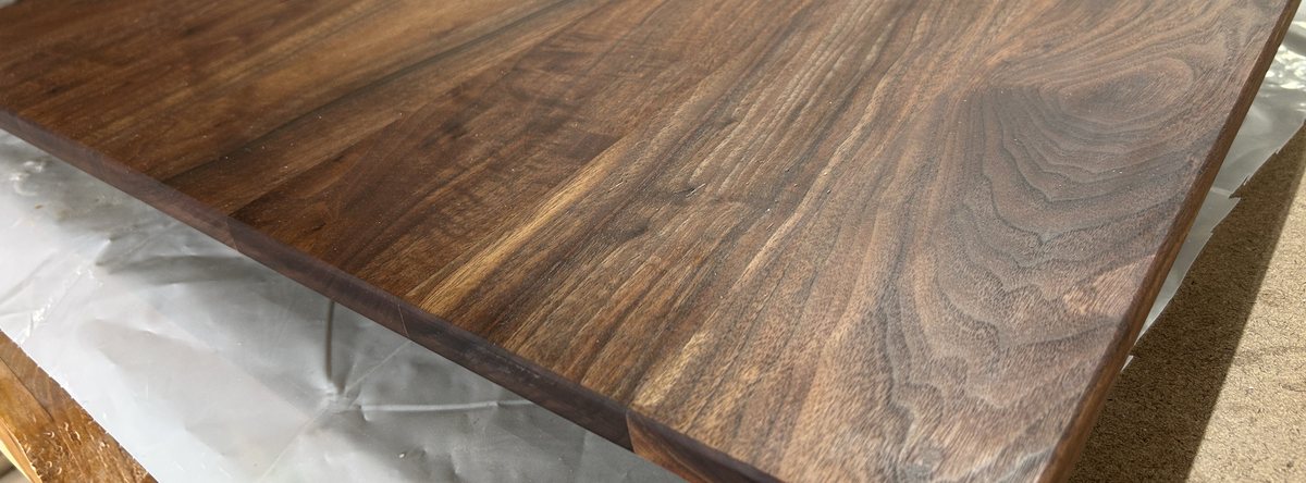 Finished walnut coffee table top with heavy grain figure